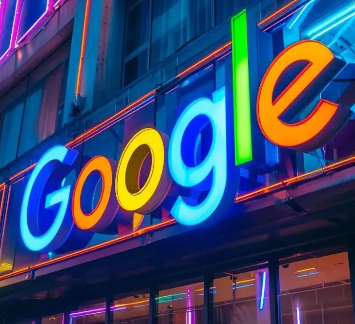 Neon Google sign lit in blue, yellow and orange