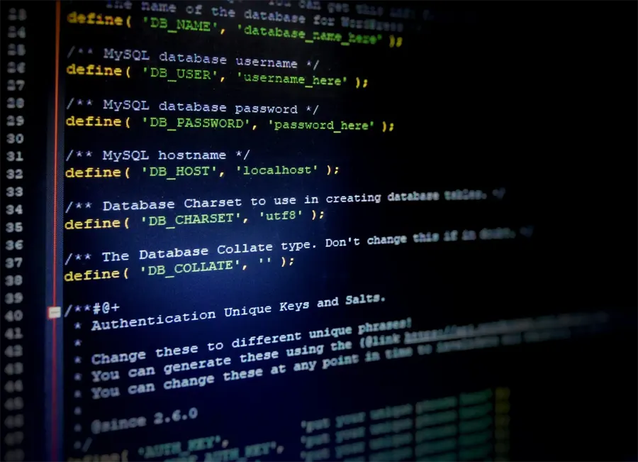 Close-up of WordPress wp-config.php code on a dark screen