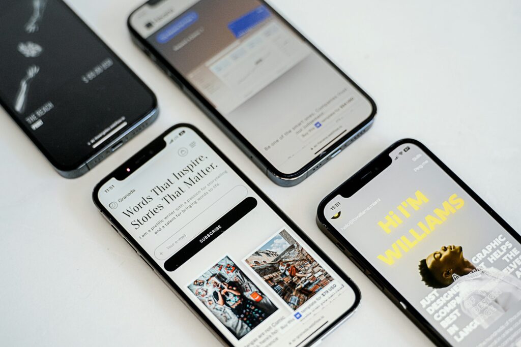 Smartphones showing mobile-friendly website designs on a white desk