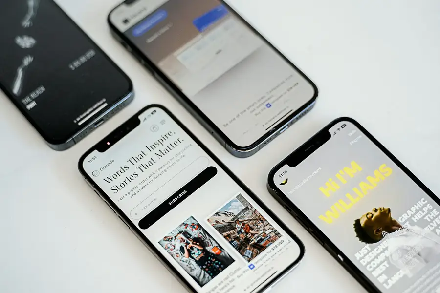 Three smartphones showing mobile-friendly website designs