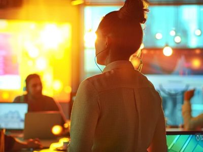 a dynamic meeting room filled with diverse professionals collaborating over vibrant digital mock-ups of websites, showcasing innovative designs on sleek laptops and large screens, illuminated by bright, modern office lighting.