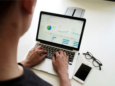 Person using laptop to analyse website performance data with graphs, charts, and statistics relevant to SEO and digital marketing strategies.