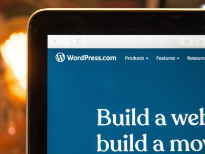 WordPress.com interface with text "Build a website, build a movement," highlighting web design services for custom WordPress solutions.