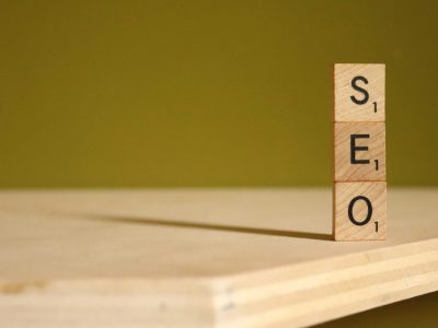 Wooden blocks spelling "SEO" on a light wooden surface, symbolising search engine optimisation, relevant to website design and digital marketing strategies.